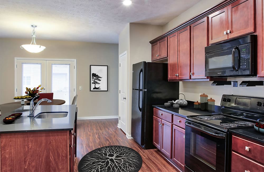 Fully equipped kitchen with a breakfast bar at Gateway Landing on the Canal in Rochester, New York