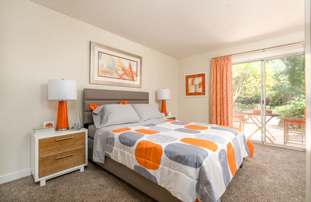 Bright apartment bedroom with plush carpeting at The Hundred Exchange in Fayetteville, Georgia