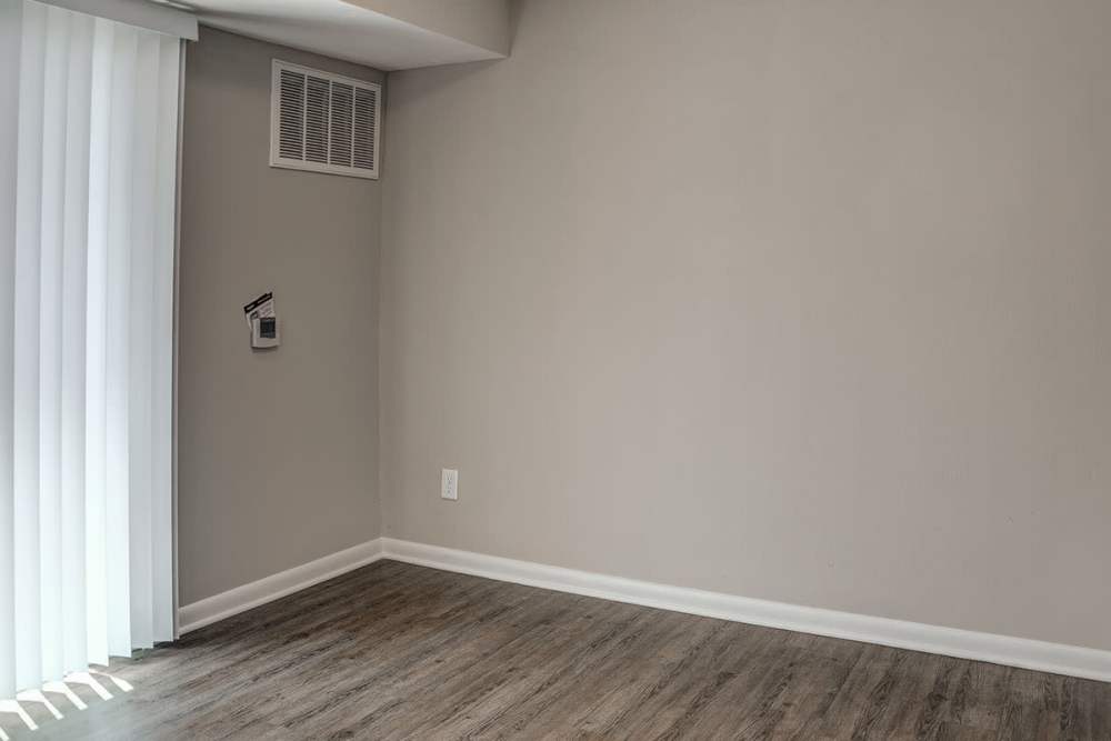 Apartment living room with air conditioning at Bell Diamond Manor in Norfolk, Virginia