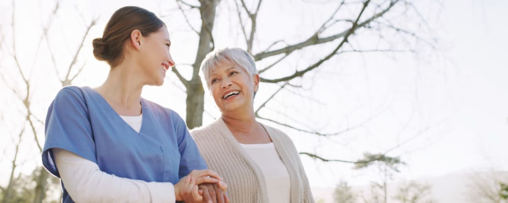 Resident and caretaker taking a walk outdoors together at Liberty Arms Assisted Living in Youngstown, Ohio