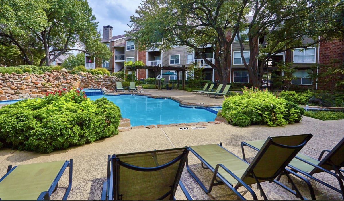 Swimming pool with lounge chairs at South Pointe in Dallas,Texas