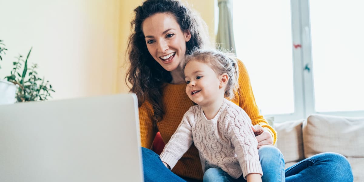 Resident working on computer with daughter at Marquis at Ladera Vista in Austin, Texas