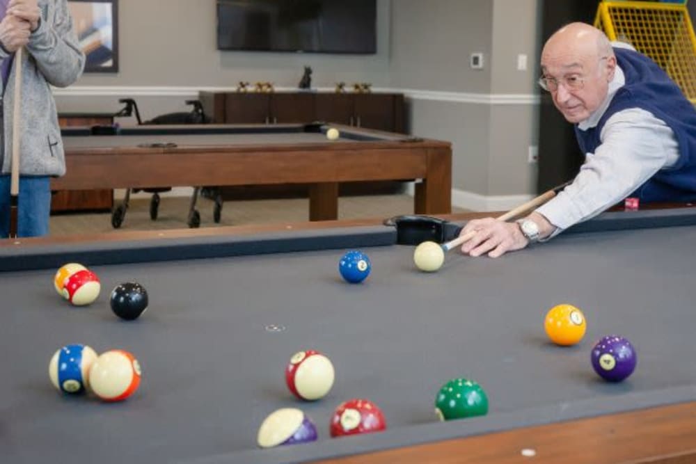 A resident playing pool at Mercer Hill at Doylestown in Doylestown, Pennsylvania
