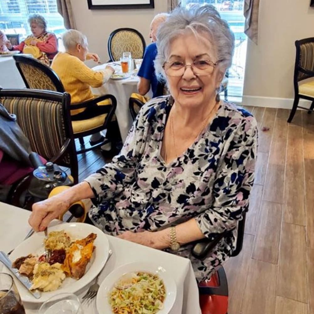 A resident enjoying a delicious meal at Inspired Living Lewisville in Lewisville, Texas.