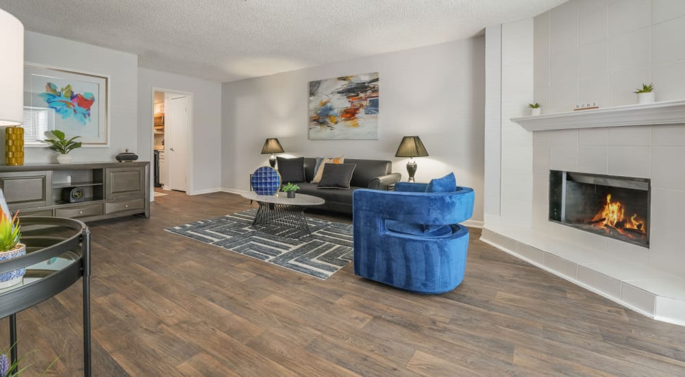 Beautiful living space with fireplace and wood-style flooring at Lakebridge Townhomes in Houston, Texas