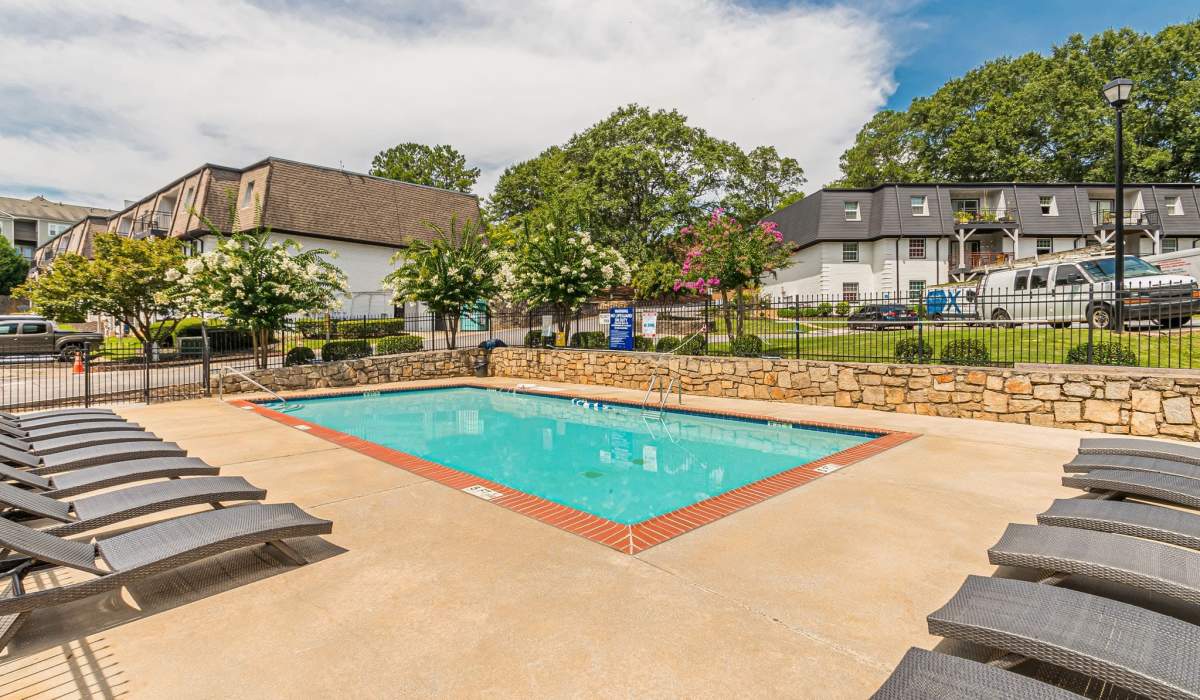 Pool with lounge chairs at Pines at Lawrenceville in Decatur, Georgia