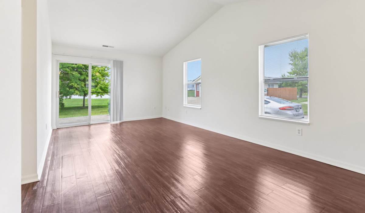 Living room with close access to patio at Broadway Village Apartments in Greenfield,Indiana