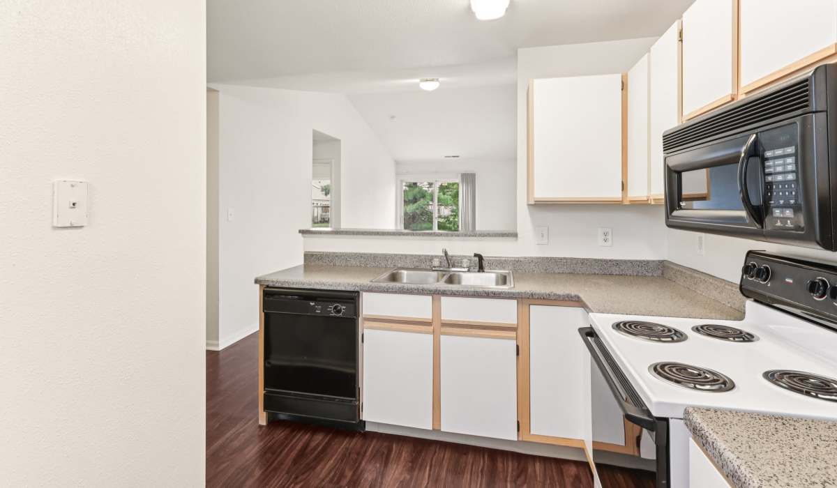 Kitchen with white appliances at Broadway Village Apartments in Greenfield,Indiana