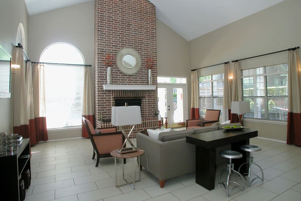 Resident clubhouse with vaulted ceilings and a fireplace at Castlegate Collier Hills in Atlanta, Georgia