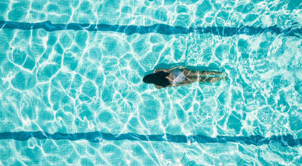 Person swimming in the pool at Bellrock Summer Street in Houston, Texas