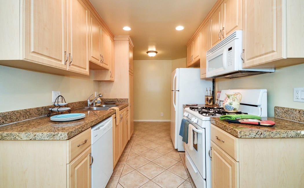 Gourmet kitchen with granite countertops in model home at IMT Beverly Arnaz in Los Angeles, California