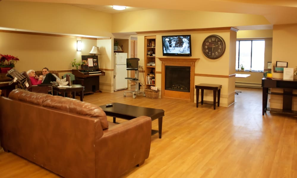 Relaxing living room area with fireplace at East Troy Manor in East Troy, Wisconsin