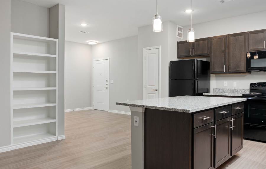 New kitchen with granite countertops at Balcones Trails in Kyle, Texas