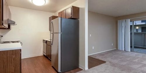 Modern kitchen and carpeted living room at Park Club Apartments in Rohnert Park, California