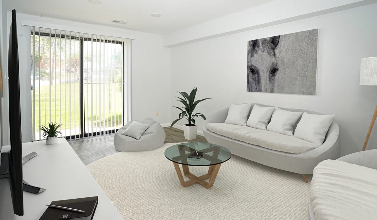 Bright living room with modern furniture, large windows, and a cozy atmosphere at Dutch Village Apartments in Baltimore, Maryland 