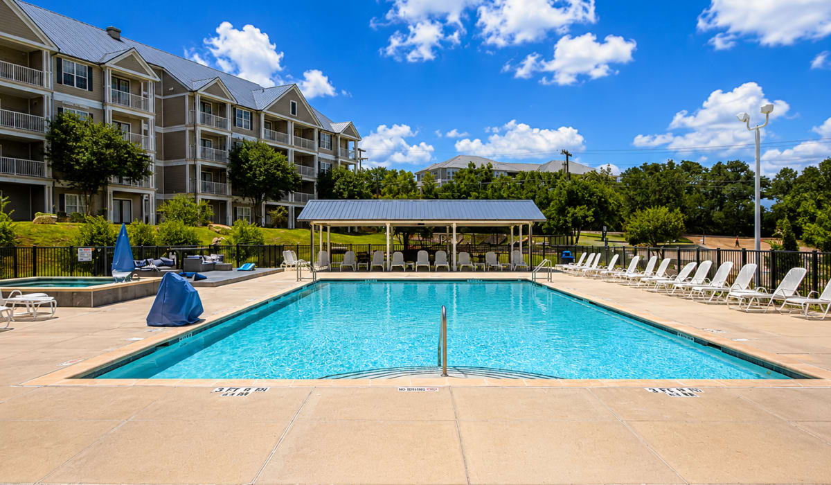 Swimming pool with lots of lounge style chairs  at The April in Canyon Lake, Texas
