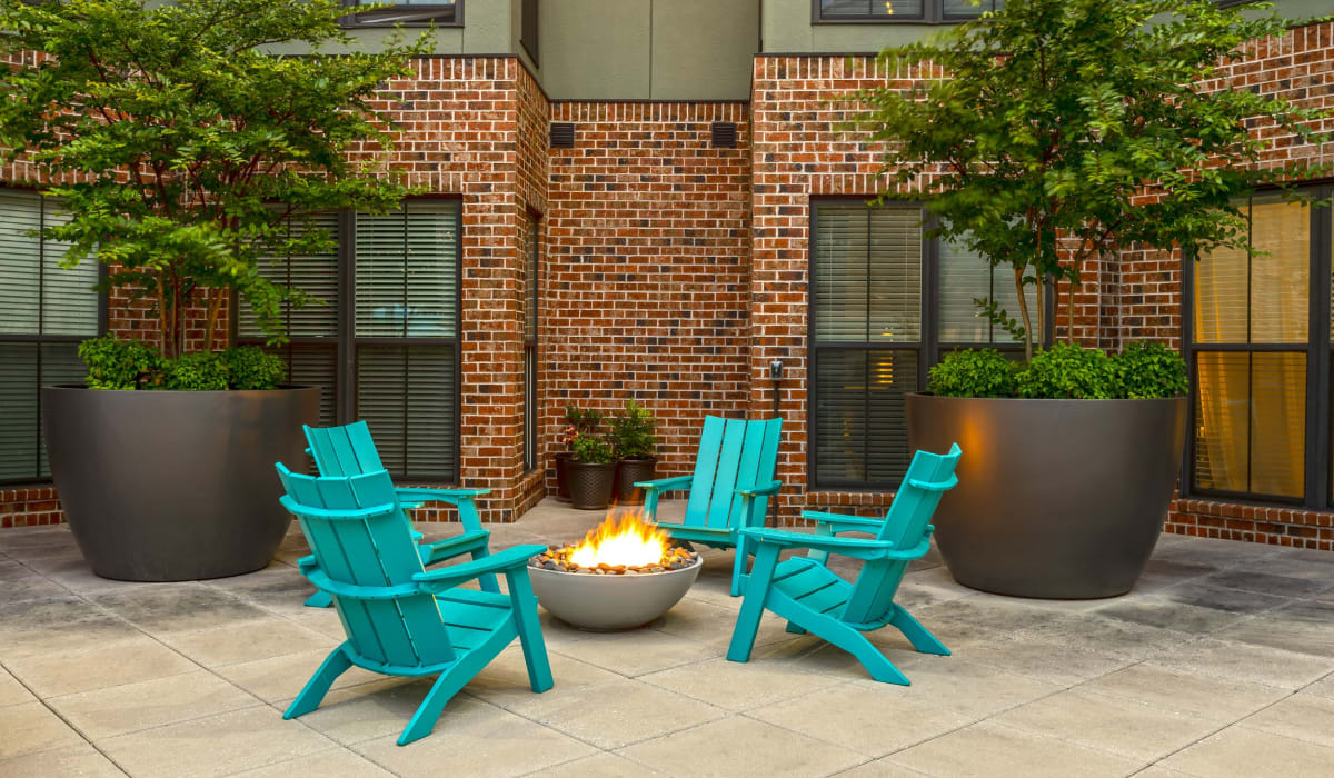 Stylish outdoor firepit surrounded with chairs at 1400 Chestnut Apartments, Chattanooga, Tennessee