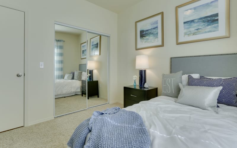 Spacious master bedroom with plush carpeting at The Landings at Morrison Apartments in Gresham, Oregon