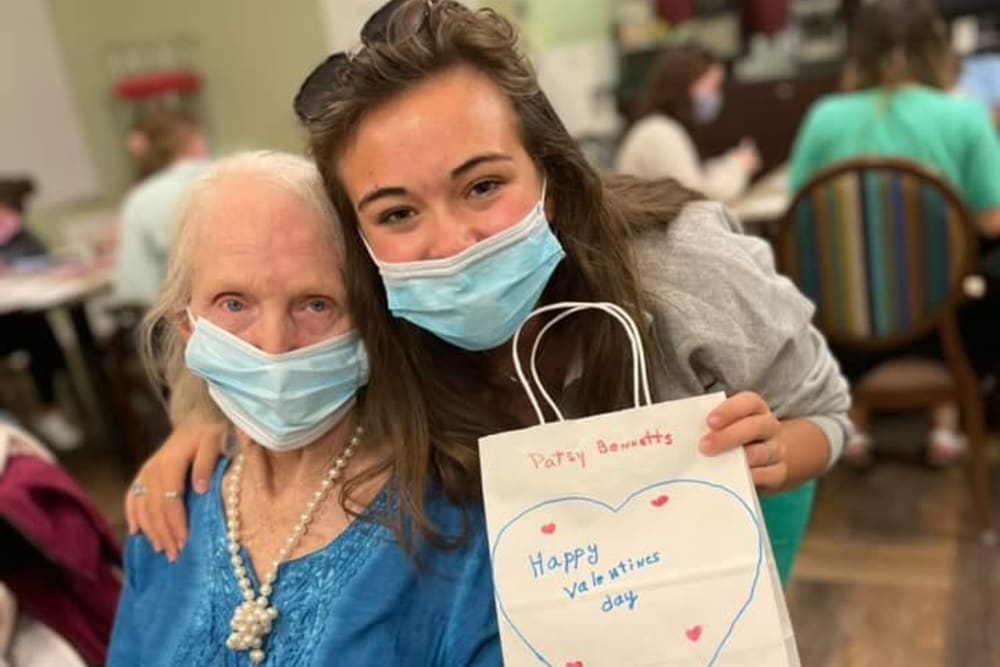 Resident and a caretaker trading valentines at Carolina Gardens at Conway in Conway, South Carolina