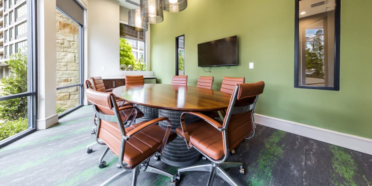 Private business meeting room with television monitor and large windows at Marq Uptown in Austin, Texas