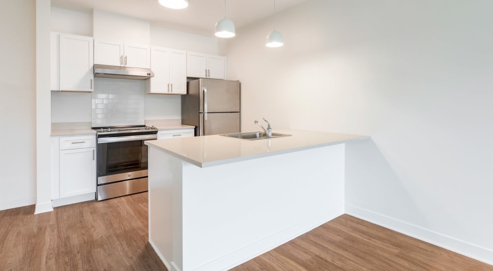 Fully equipped kitchen with white cabinetry at Metro Green Court in Stamford, Connecticut