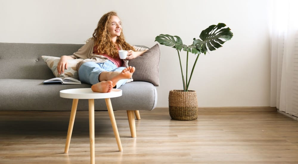 A resident relaxes in her apartment at The Docks in New London, Connecticut