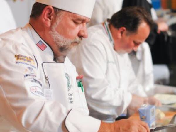 Chef and his crew preparing fresh and delicious meals in the kitchen at Arcadia Senior Living Pace in Pace, Florida