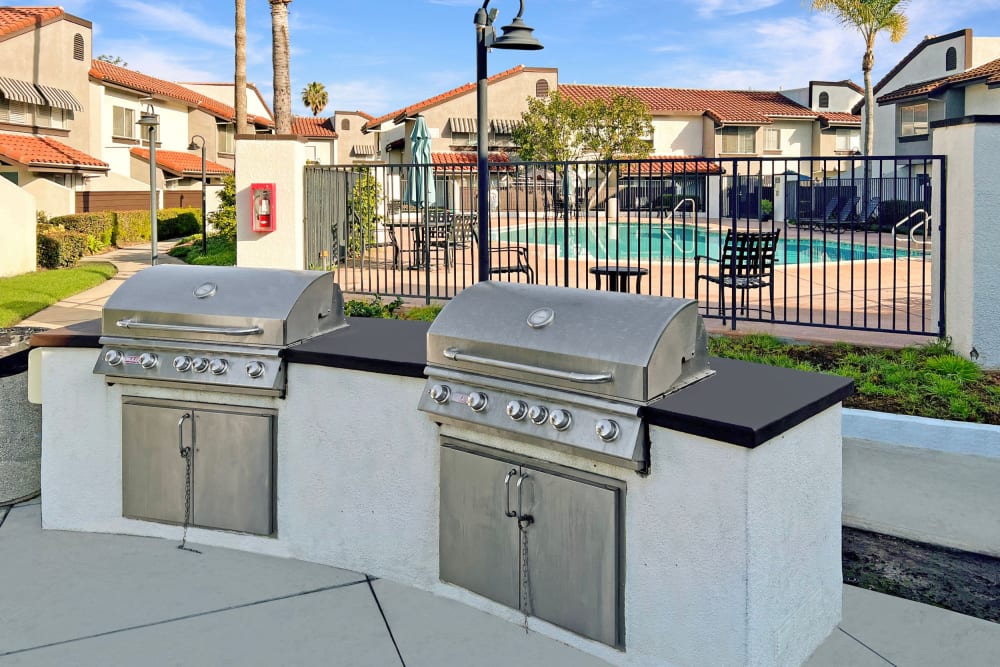 Grills by the pool at Portofino Townhomes in Wilmington, California