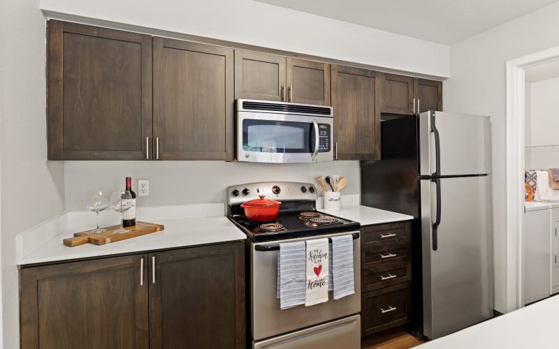 Renovated brown kitchen with quartz counters at HighGrove Apartments in Everett, Washington