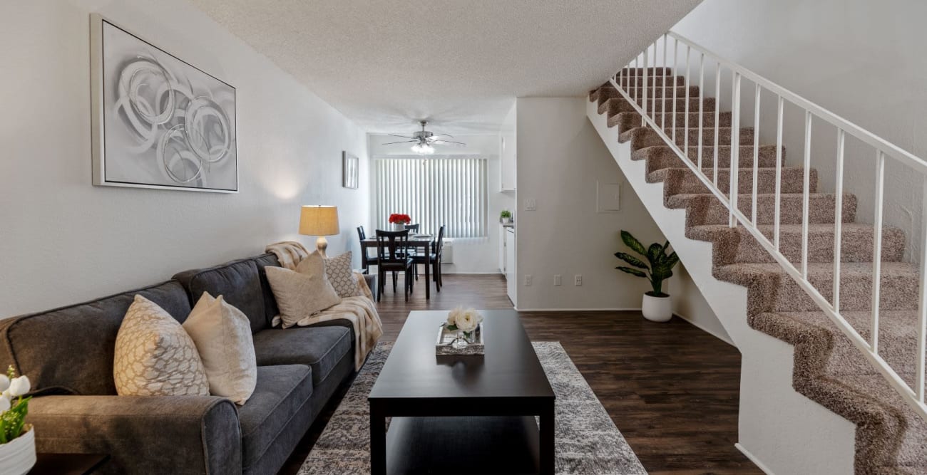 Townhome style apartment with a spacious living room, open concept dining, and stairs to access the bedroom upstairs at The Windsor in Sherman Oaks, California The Windsor in Sherman Oaks, California