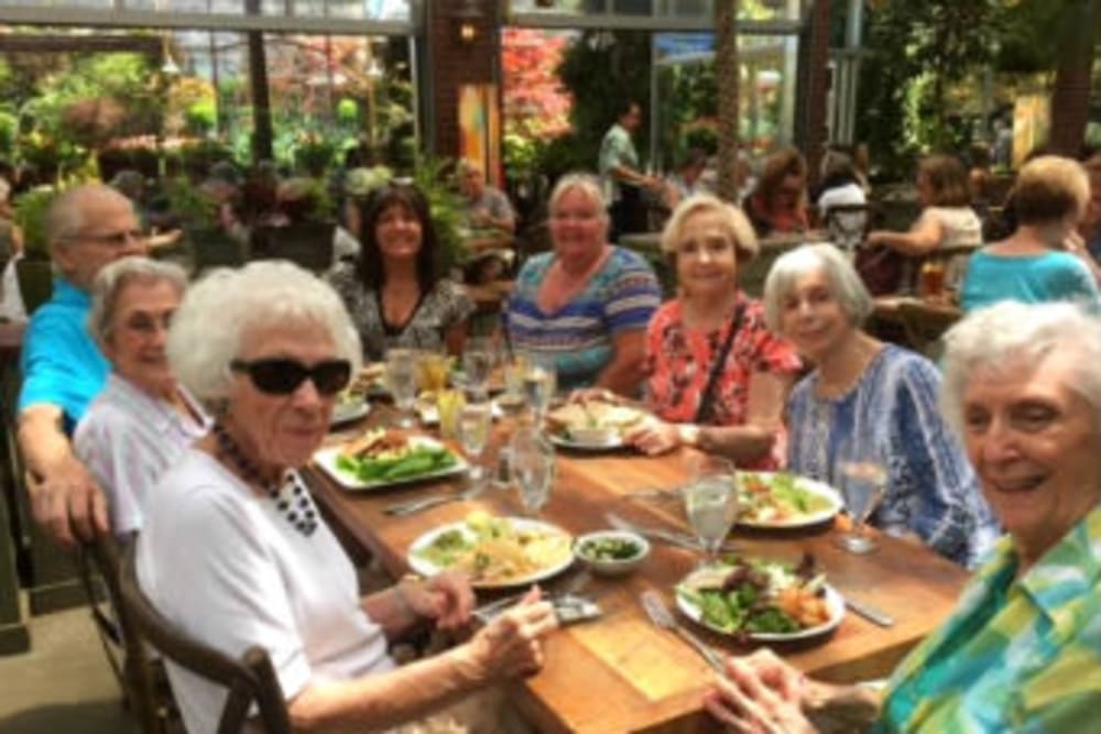 Happy friends eating lunch out and about at Hilltop Commons Senior Living in Grass Valley, California