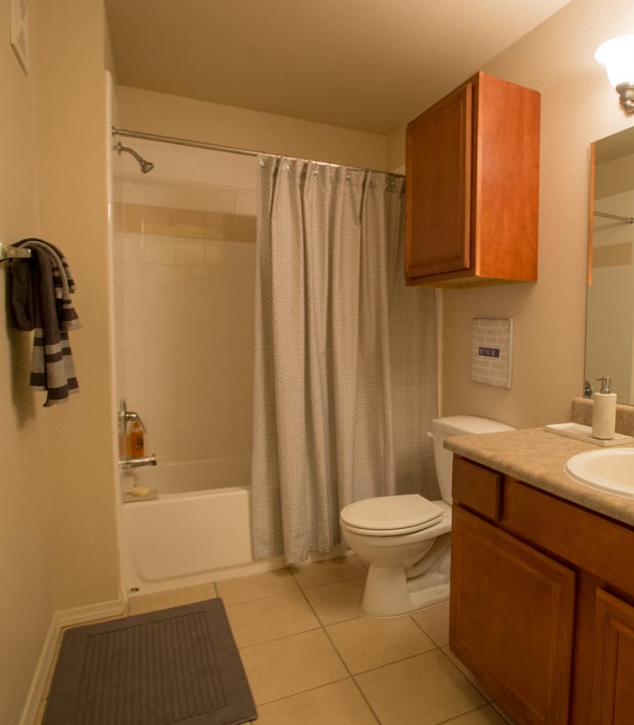 Bathroom with tile flooring at Villas of Waterford Apartments in Wichita, Kansas