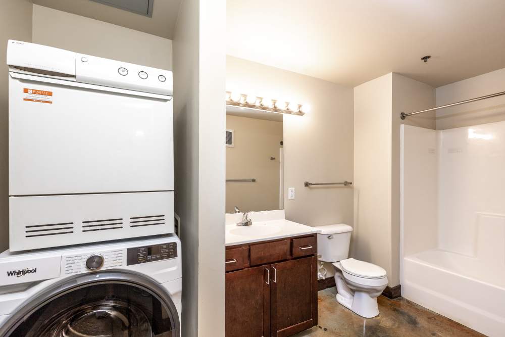 Washer and dryer stacked in bathroom at Rumely Lofts in Des Moines, Iowa