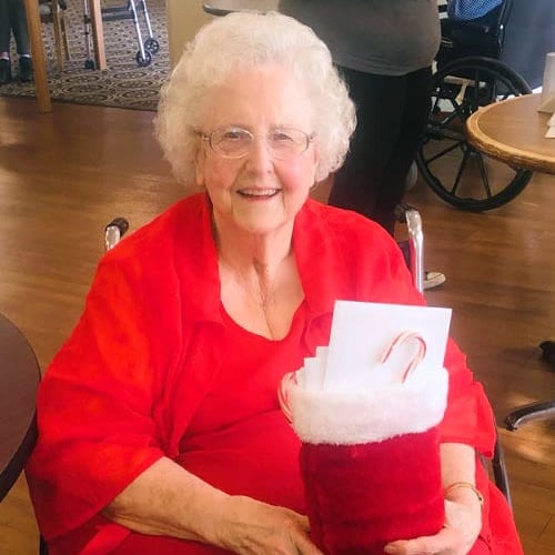 A resident holding a stocking full of small gifts at Ashbrook Village in Duncan, Oklahoma