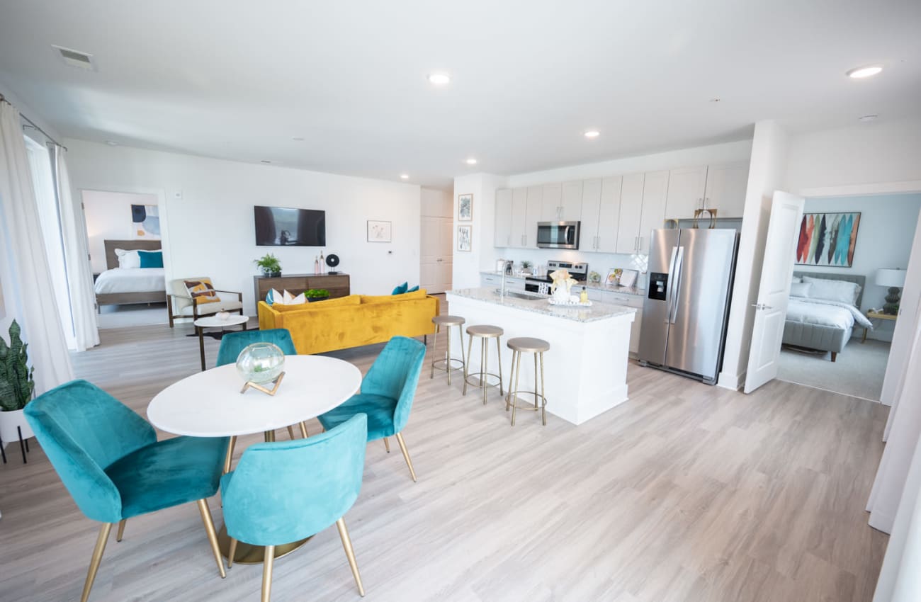 Dining room with kitchen and living room being shown in the distance