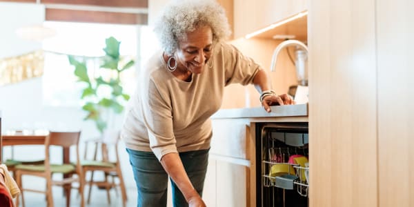 Resident putting dishes away at Ingleside Communities in Mount Horeb, Wisconsin