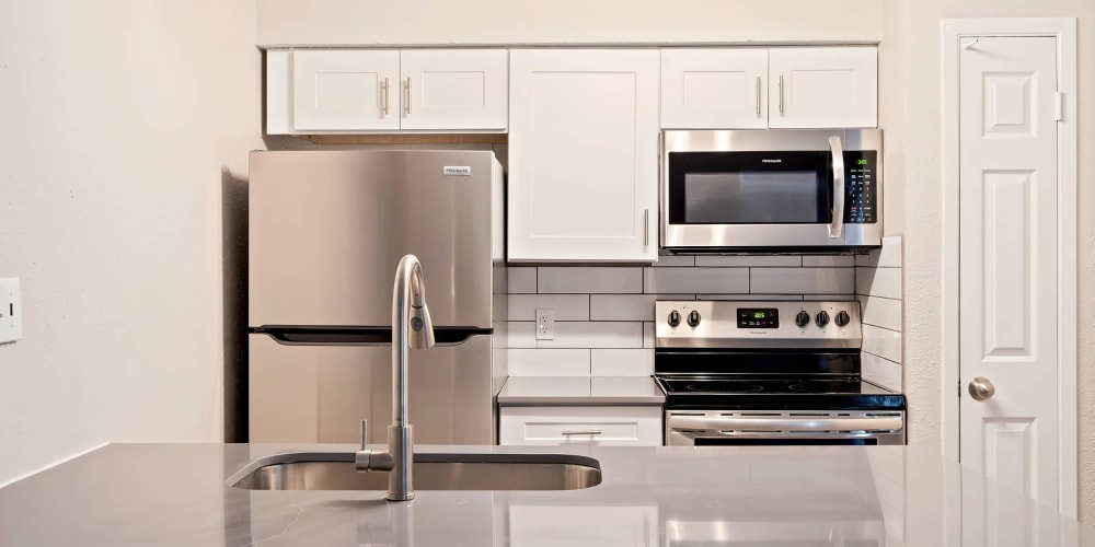 Kitchen with shiny new appliances at Tides at 5400 in Fort Worth, Texas