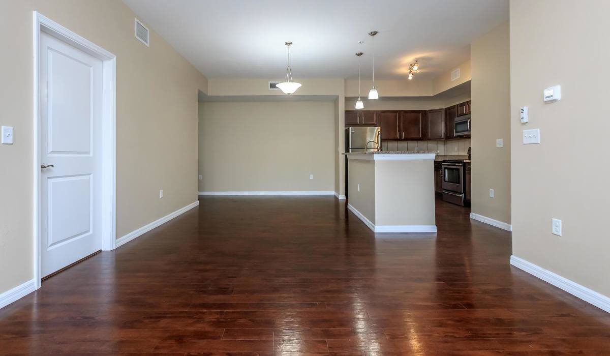 Apartment living room with view of kitchen at Adagio at Westshore Palms in Tampa, Florida