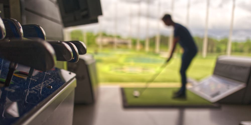 Residents practices his golf swing at Encore MidCity in Huntsville, Alabama