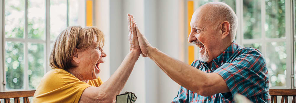 Two excited residents high fiving at a Stoney Brook community