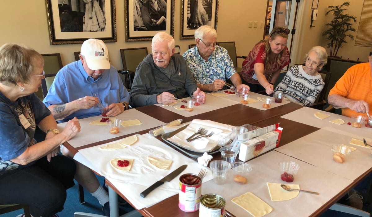 Residents making pastries together at a CERTUS Premier Memory Care Living community.