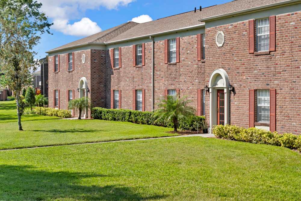 Community exterior view with trees and green lawn at Carlton Arms Of North Lakeland in Lakeland, Florida