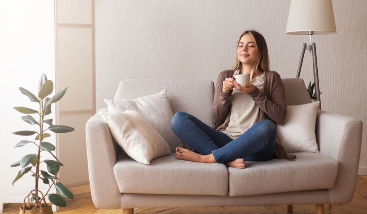 A resident enjoys a morning cup of coffee in her apartment at Attain at Bradford Creek, Huntsville, Alabama