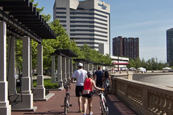 Couple walking their bikes through Cincinnati, Ohio near Lakeshore Drive