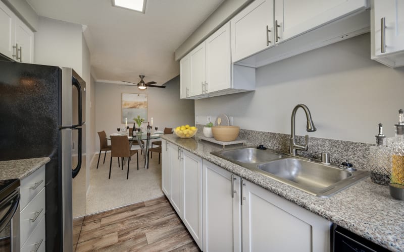 Renovated kitchen with white cabinets at Walnut Grove Landing Apartments in Vancouver, Washington