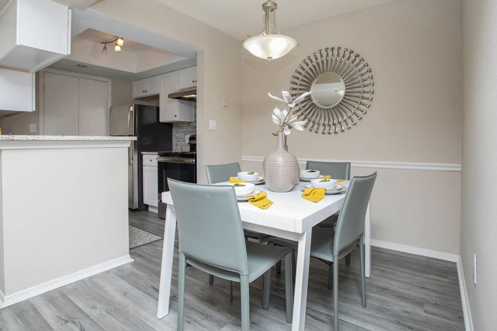 Dining area with contemporary plank flooring in a model home at Castlegate Collier Hills in Atlanta, Georgia