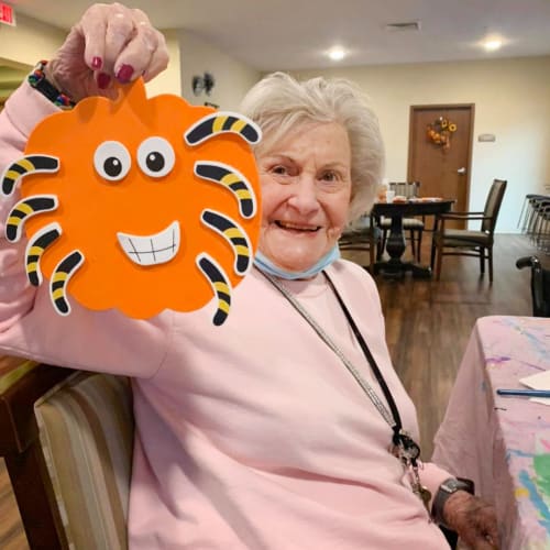 Resident holding a handmade halloween decoration at The Oxford Grand Assisted Living & Memory Care in McKinney, Texas