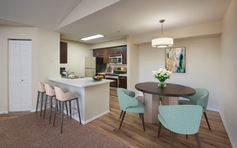 A renovated kitchen with espresso cabinets at The Crossings at Bear Creek Apartments in Lakewood, Colorado