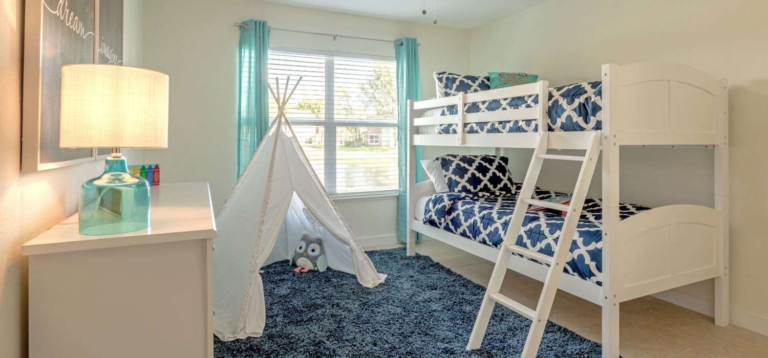 Bedroom with large windows at Visions at Willow Pond apartments in West Palm Beach, Florida