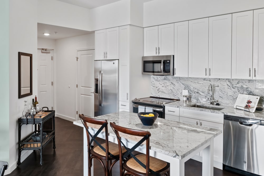 Model kitchen with adaptable island and quartz countertops at Oceanside Lantana in Lantana, Florida